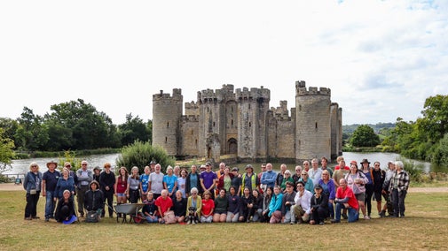 Group of volunteers and archaeologists at an excavation site at Bodiam Castle